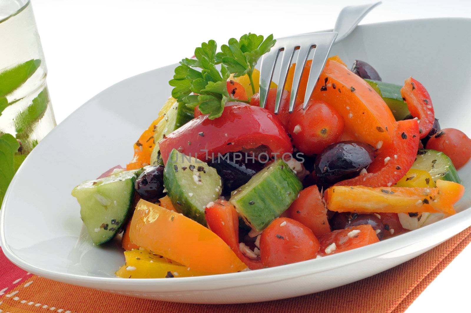 Colorful and tasty vegetable salad in a white bowl.