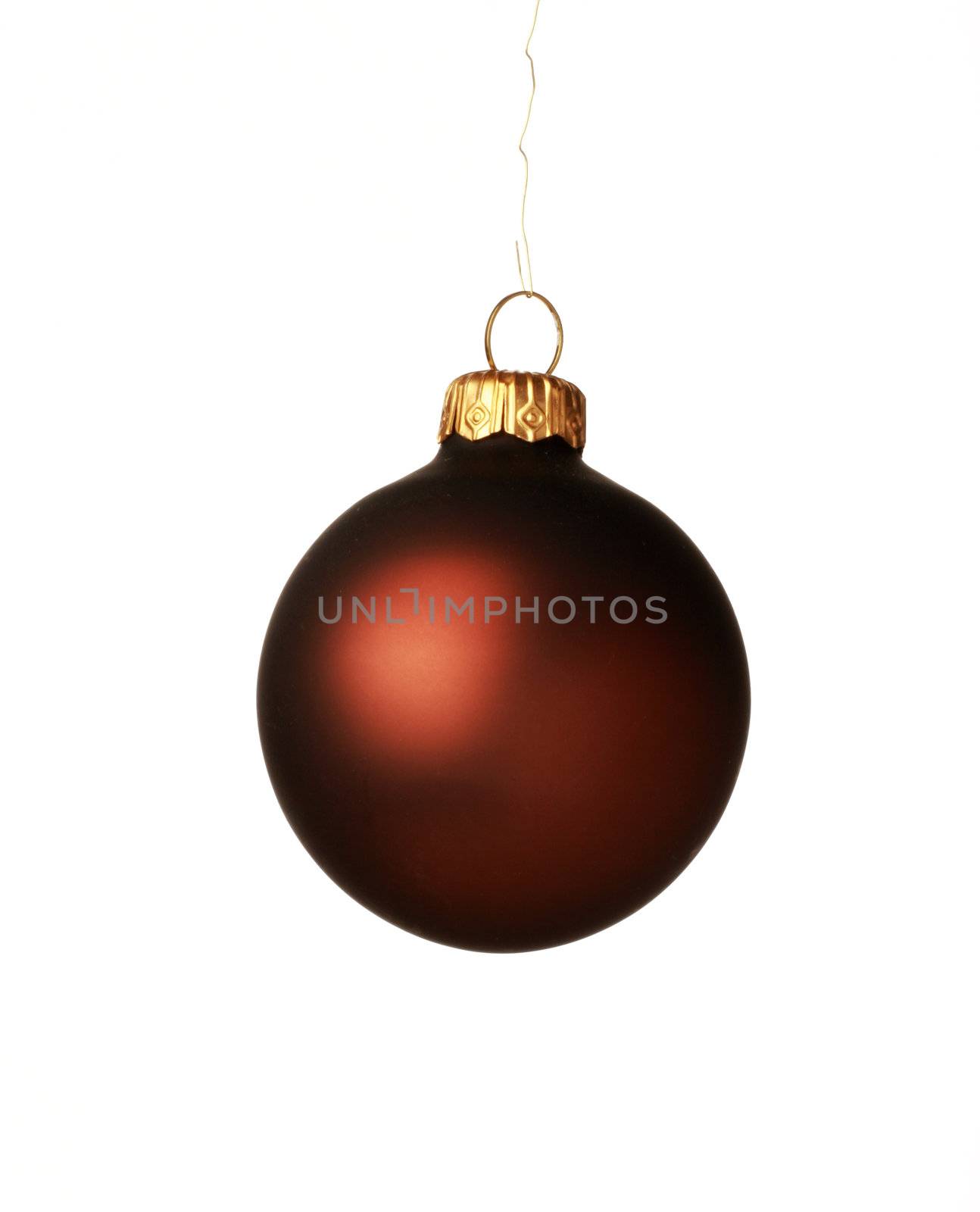 A brown christmas ball hanging from golden thread, shot in studio isolated on white. Perfect for your holiday designs or ads