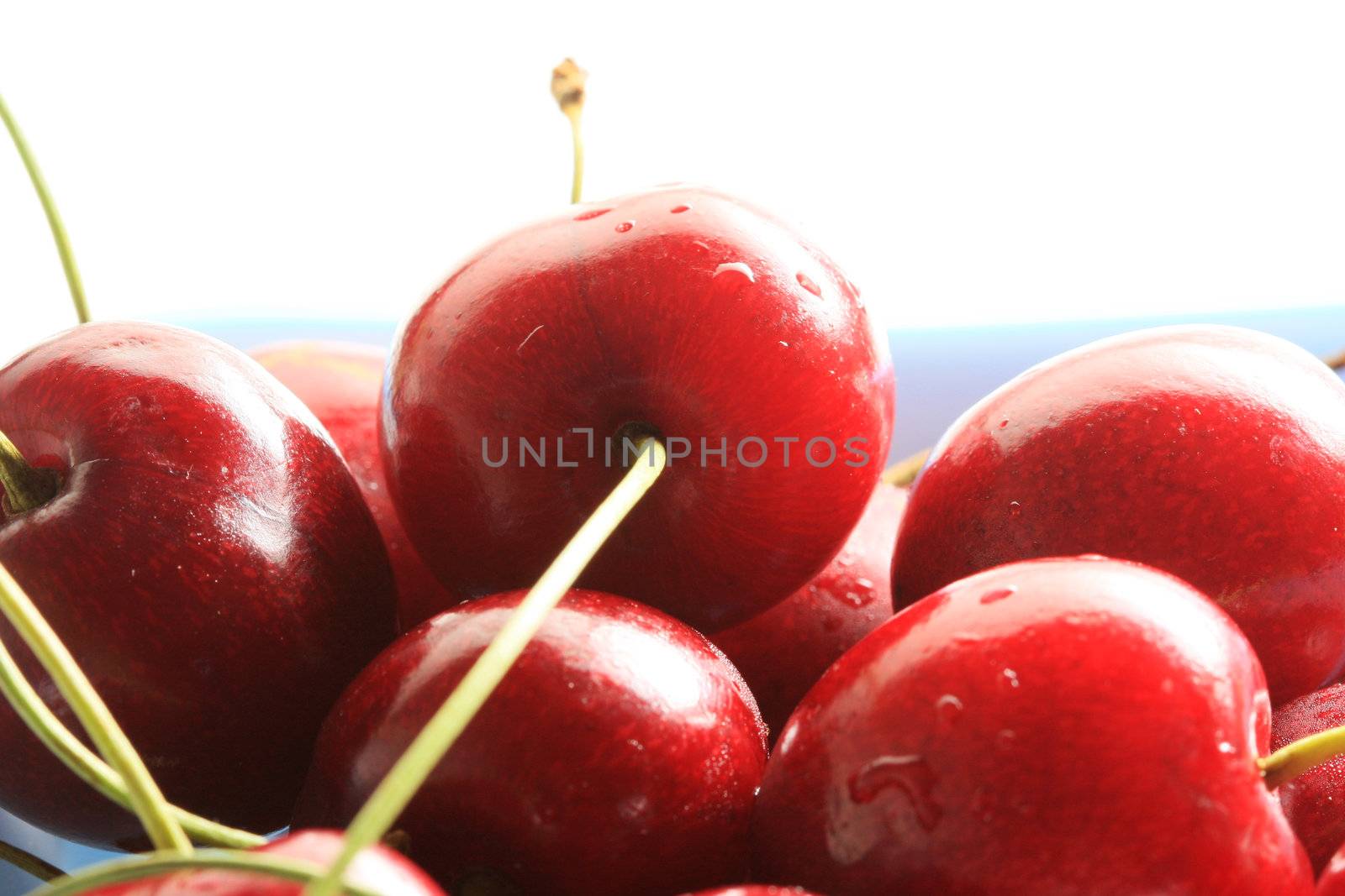 Bowl of fresh cherries, high key lighting from behind