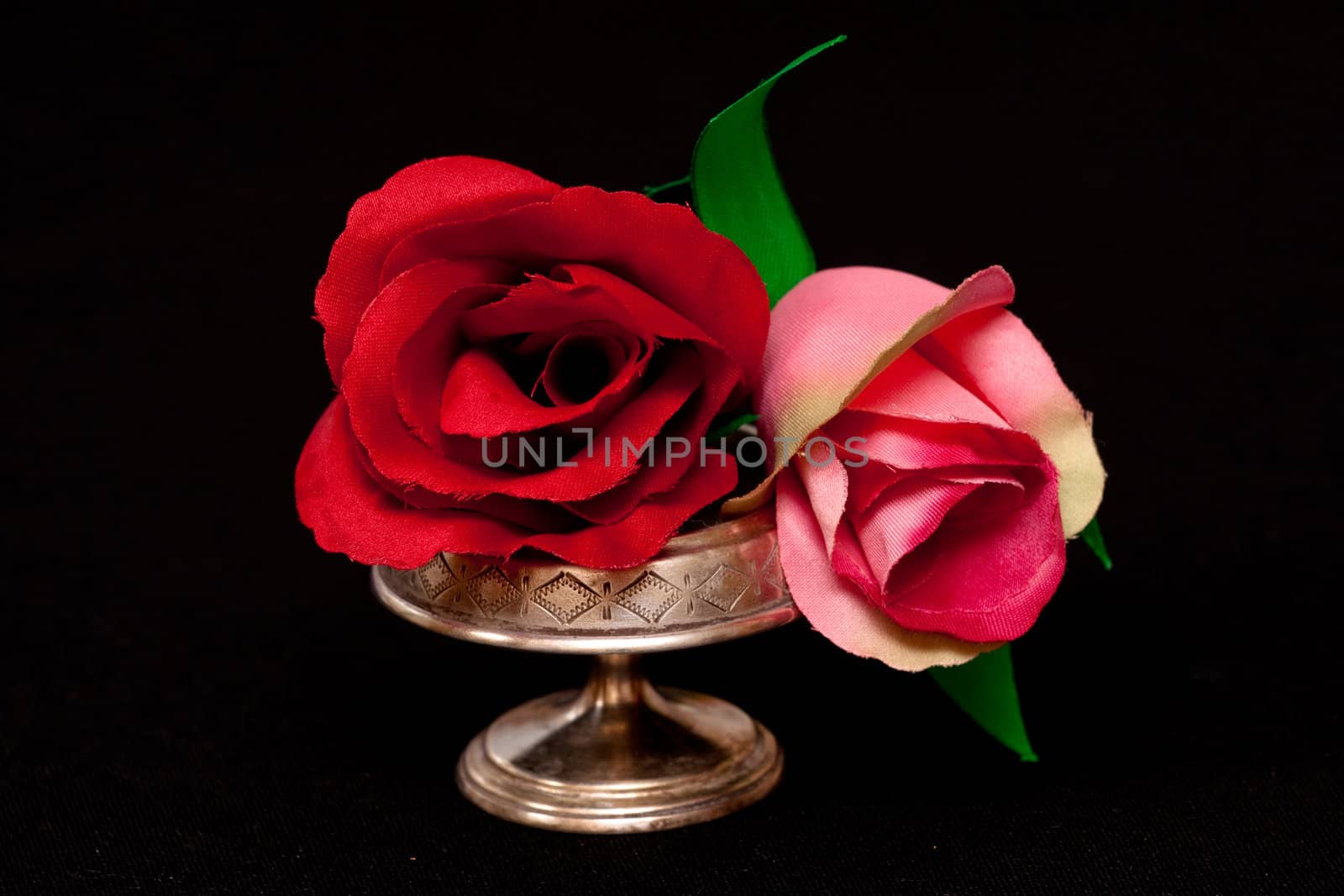two artificial handmade roses on black
