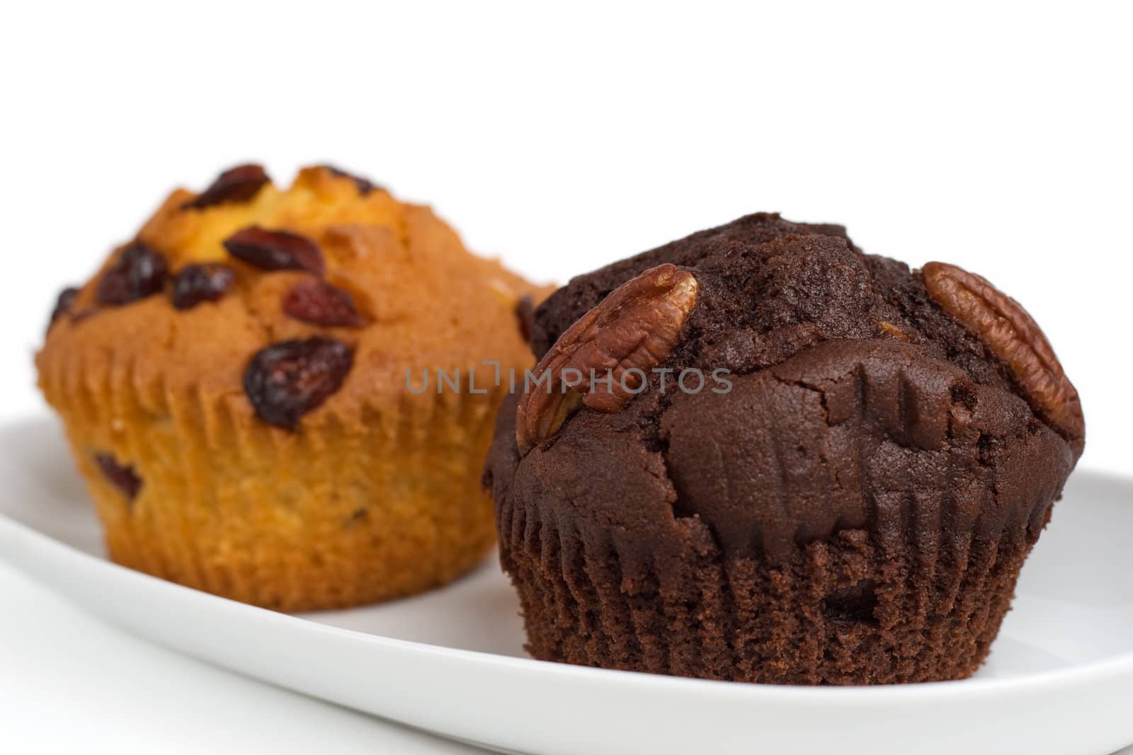 two muffins on a plate, shallow DOF, isolated