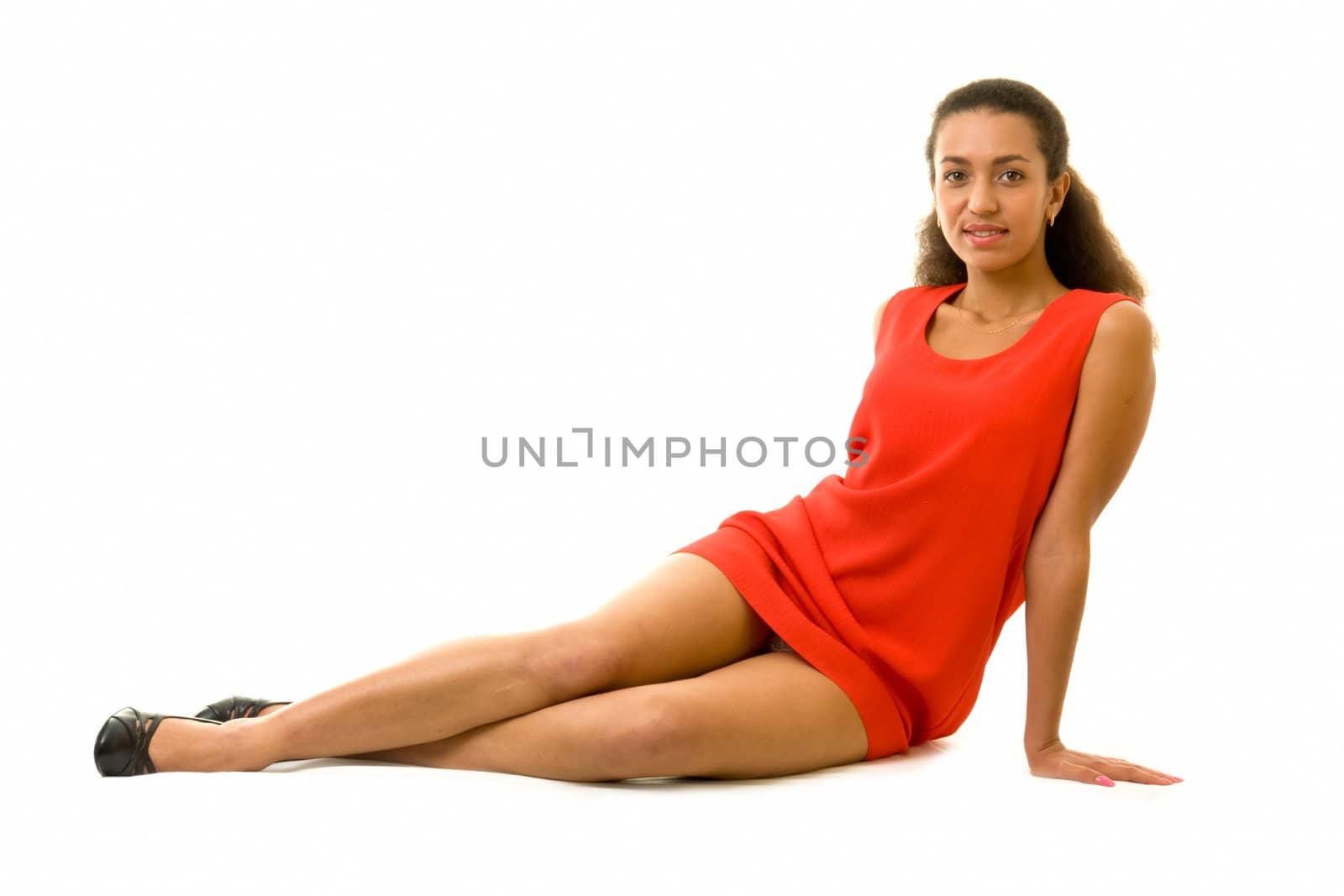 Sexy young woman in a little red dress, isolated on white