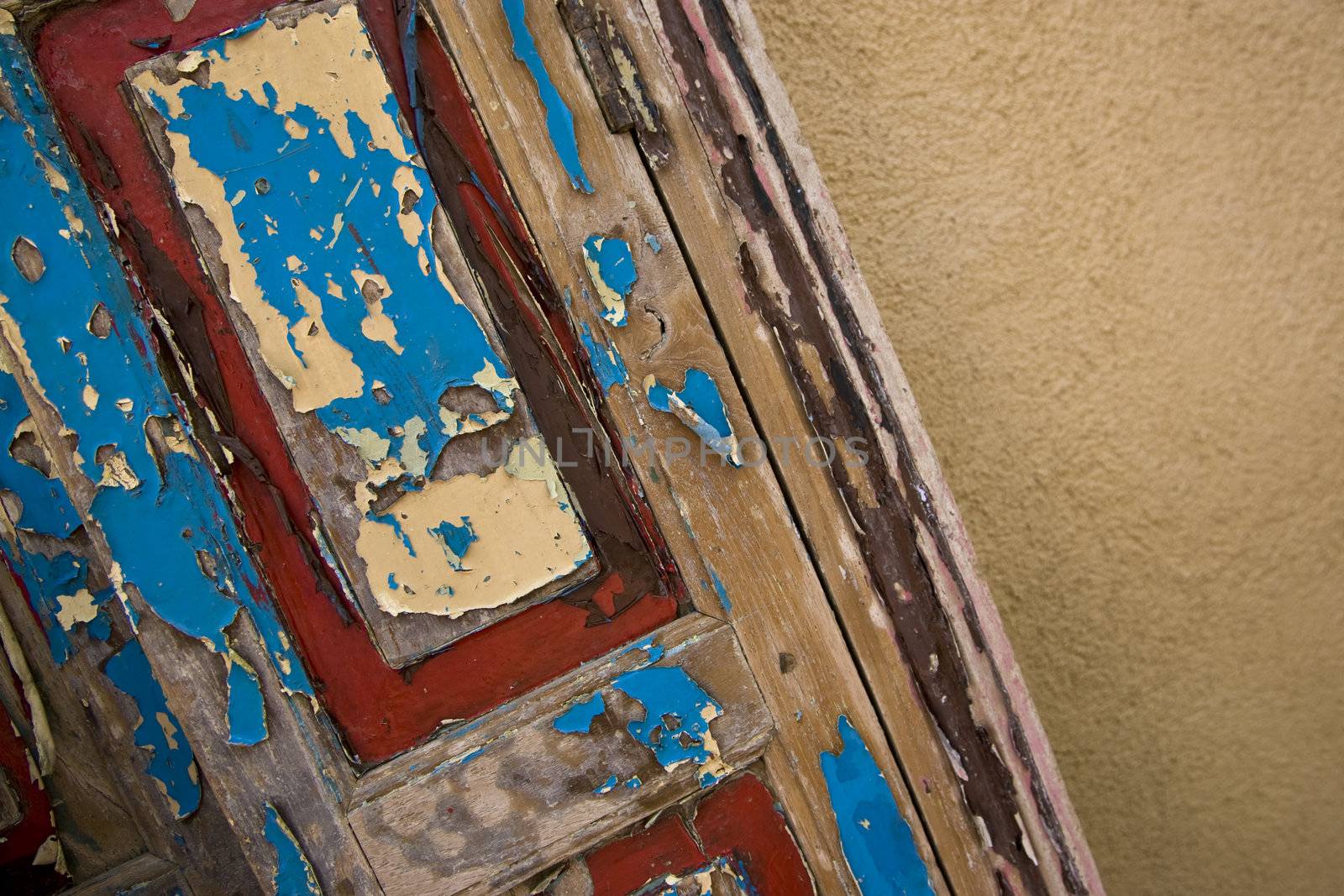 A detail of an old painted wooden door.