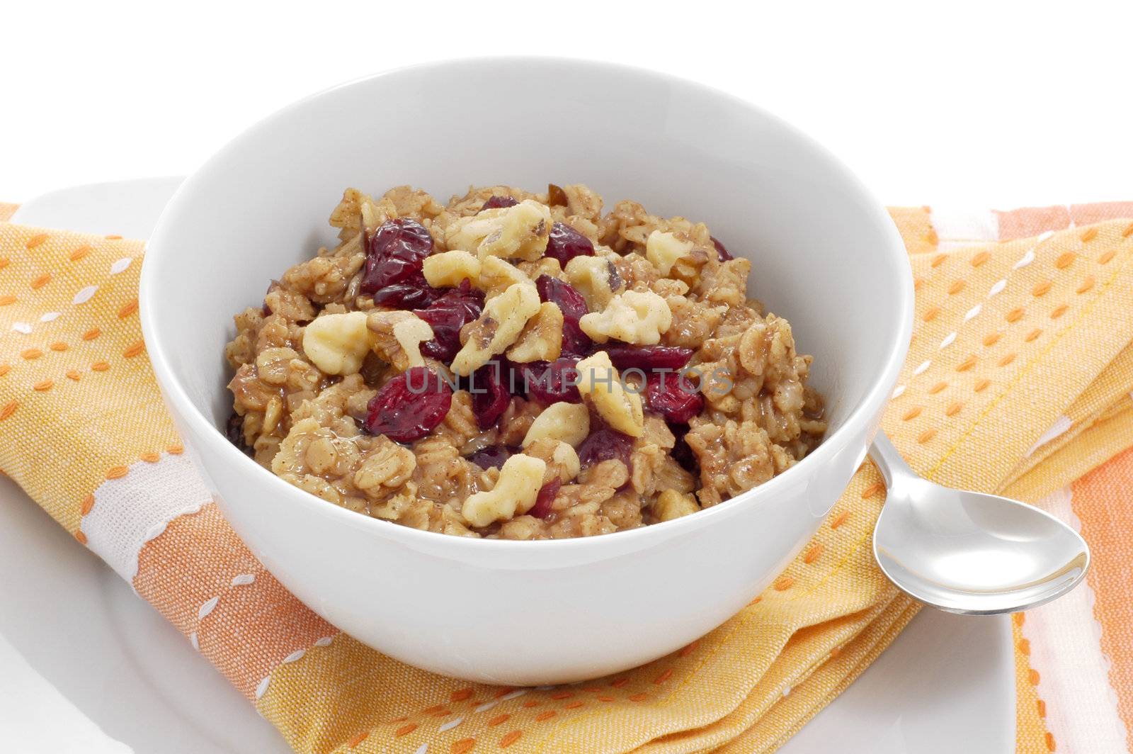 Bowl of oatmeal with dried fruit and nuts.