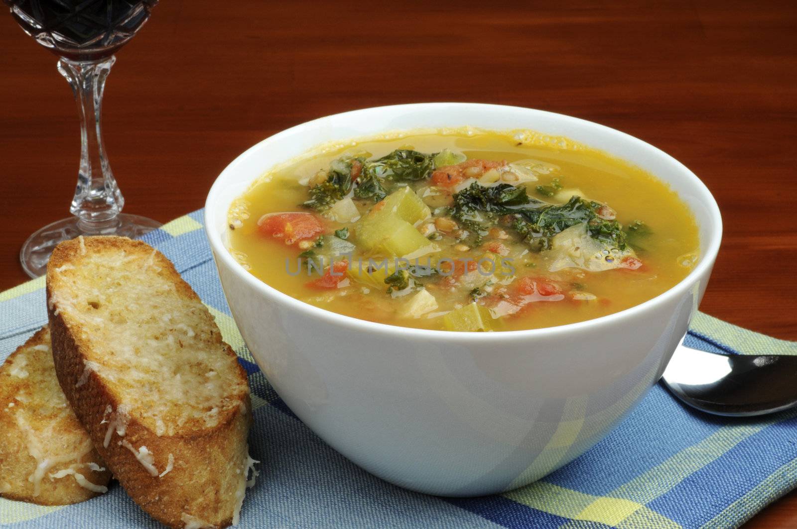 Bowl of homemade vegetable soup with crusty bread.