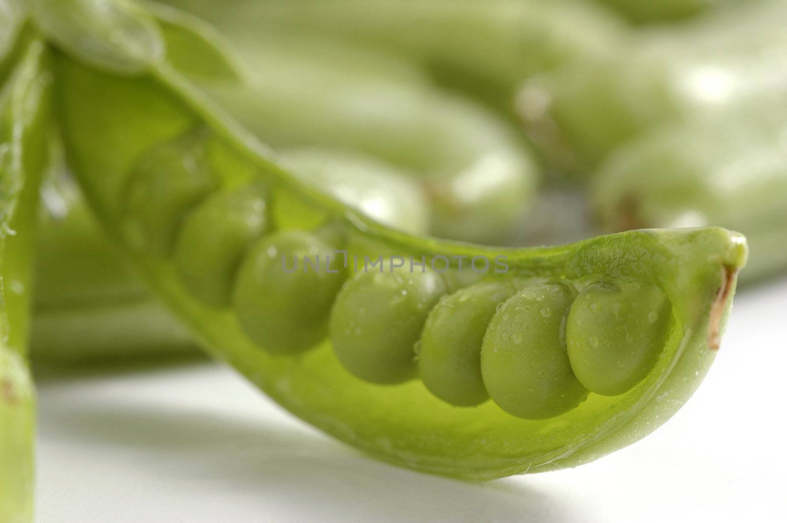 Fresh green sugar snap peas in the pod.