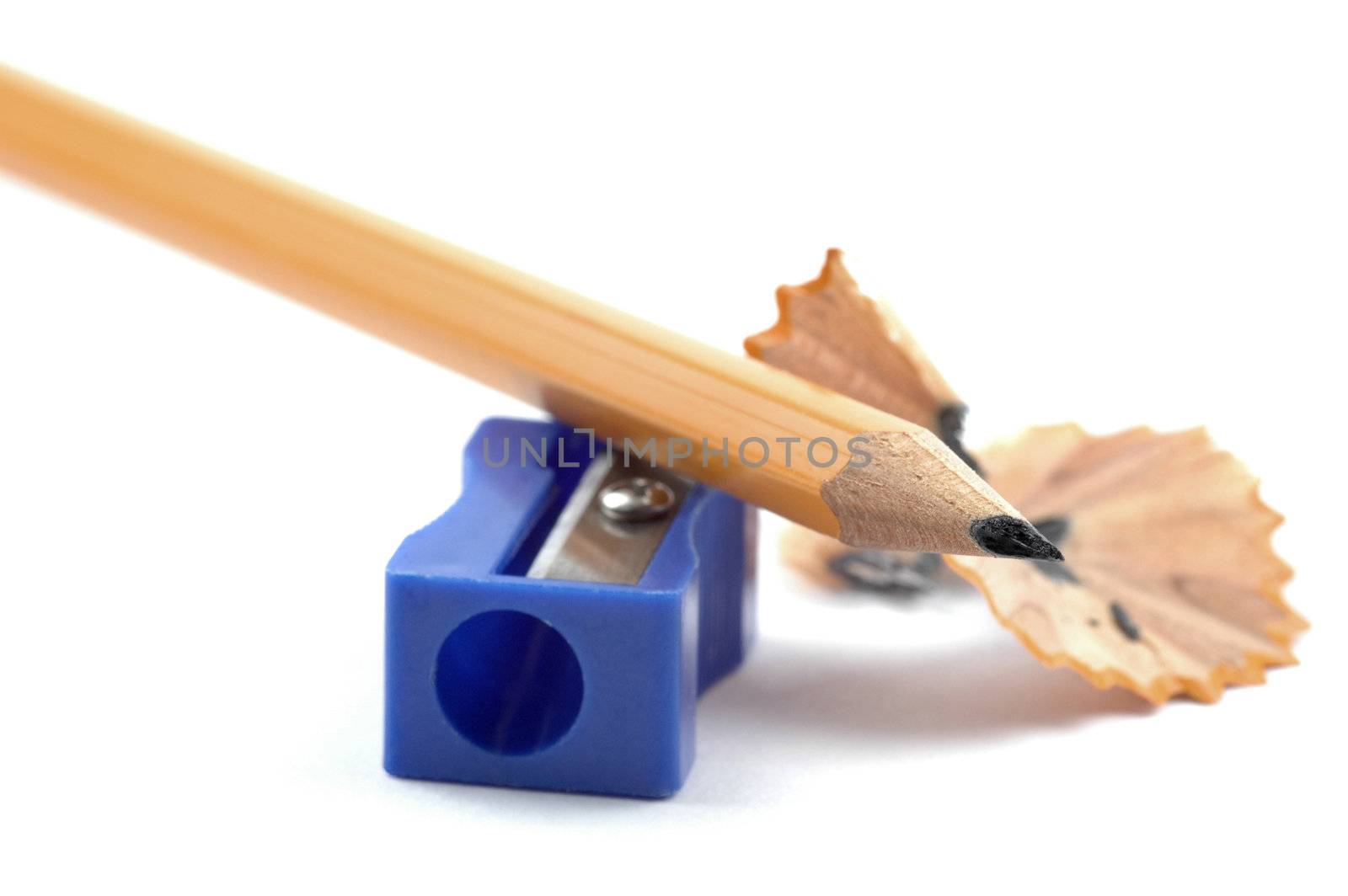 Close-up of a sharpened pencil and sharpener.