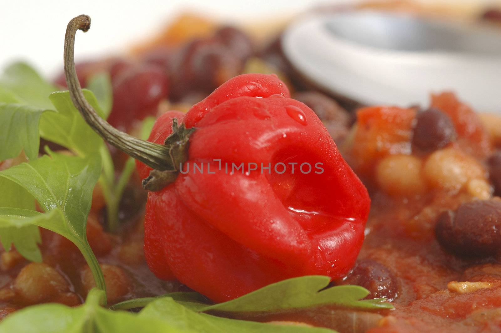 Bright red hot pepper garnishing vegetarian chili.