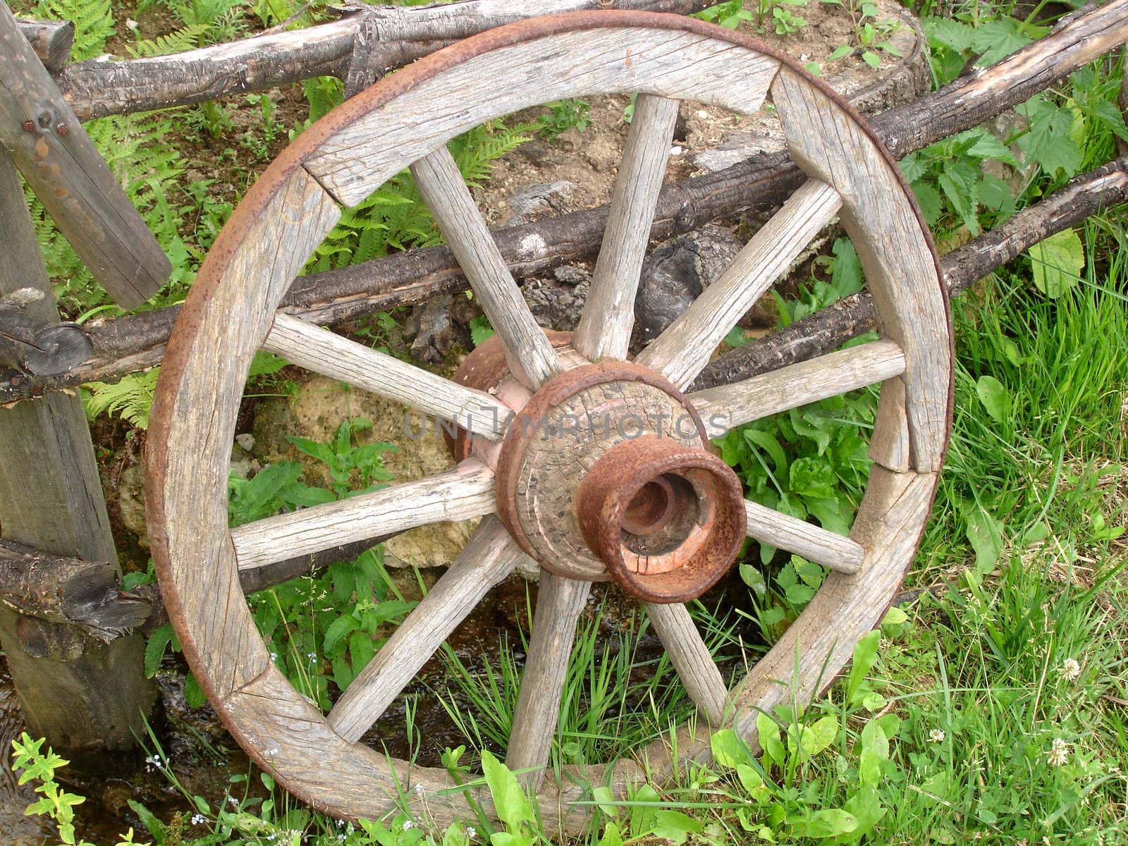 Wooden Horse Carriage Wheel Leaned on a Fence