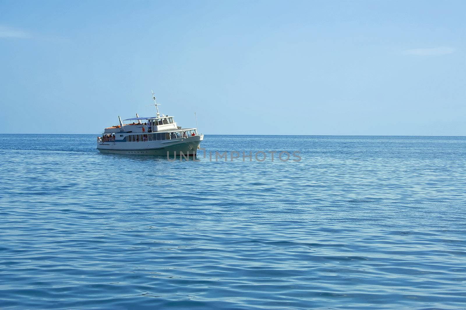 Pleasure boat at sea rolled tourists by selhin