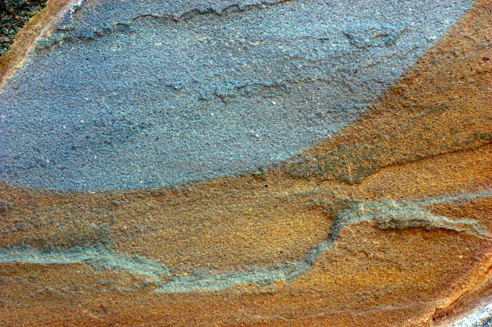 colored (prevaling blue and brown) rough stone surface