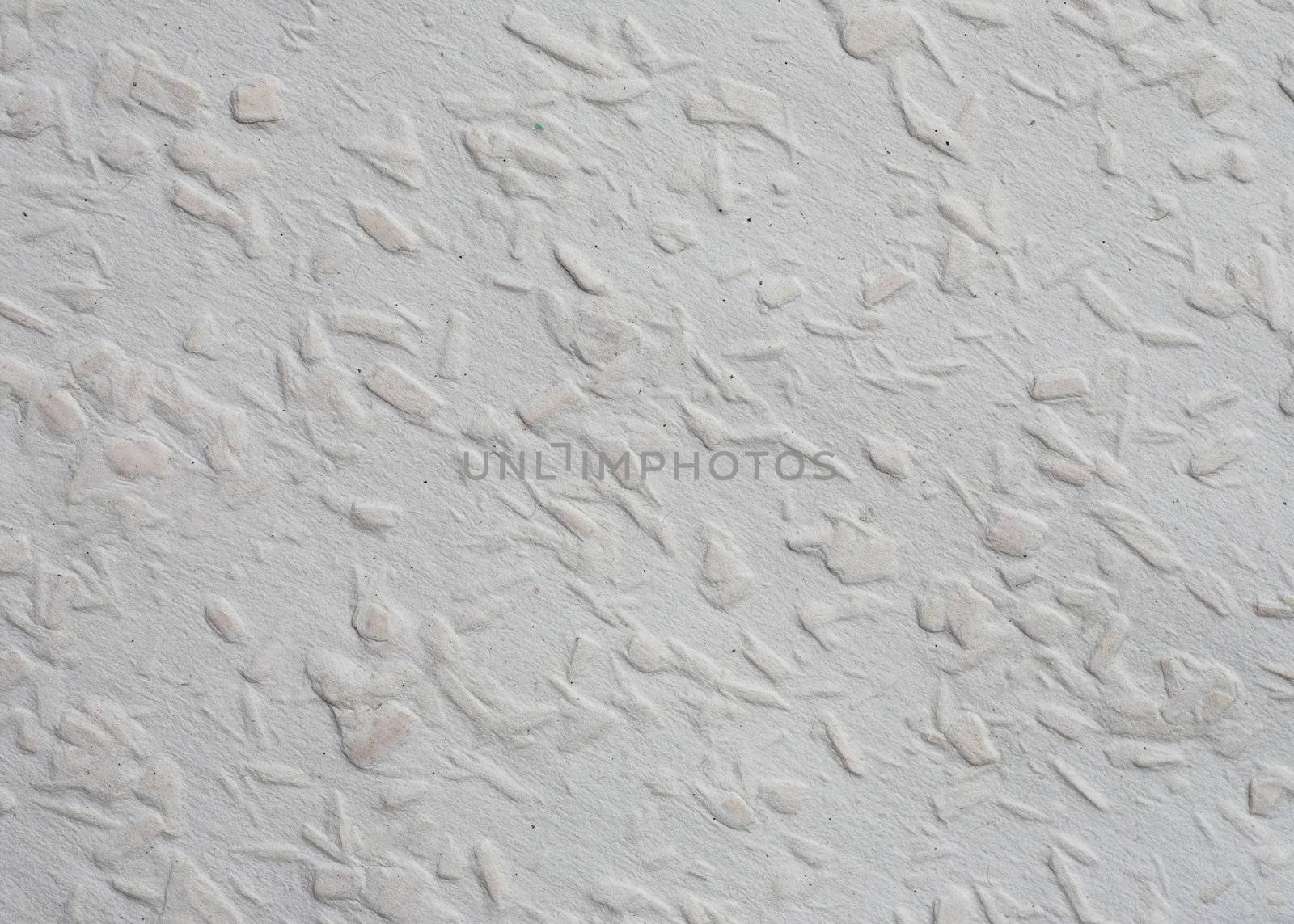 Textured surface of a sheet of woodchip wallpaper