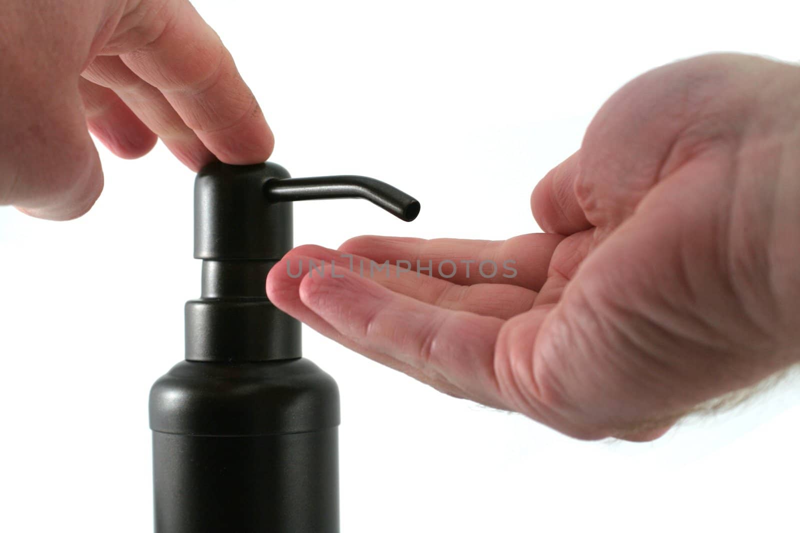 A hand soap dispenser being used, isolate on a white background.
