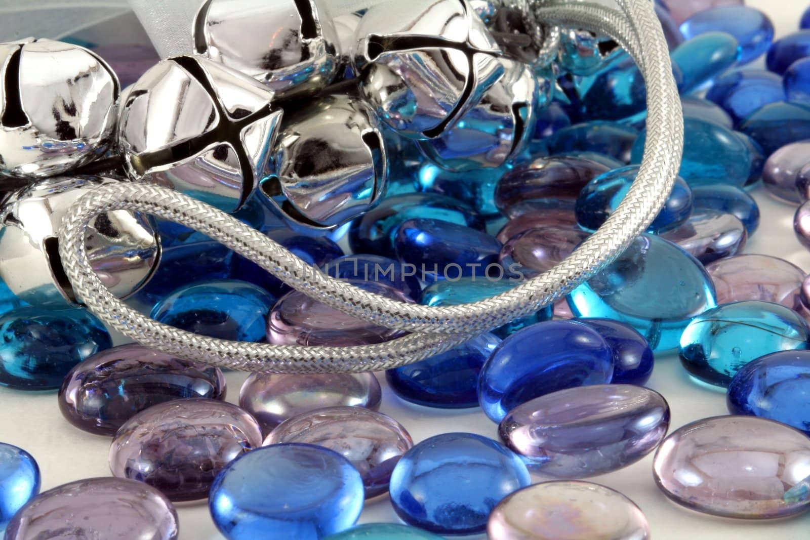 Silver Christmas bells with blue glass stones.