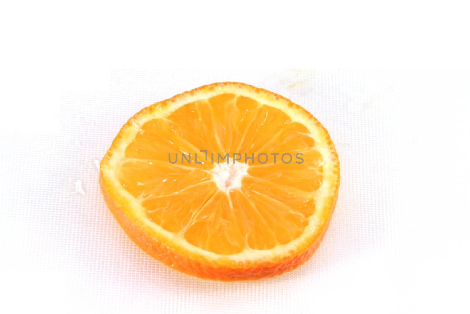 A fresh orange slice isolated on white.
