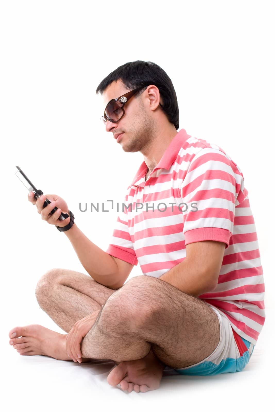 Young man with mobile phone on a white background.