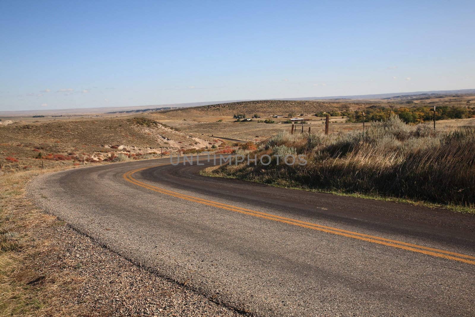 Isolated winding road in American Great Plains