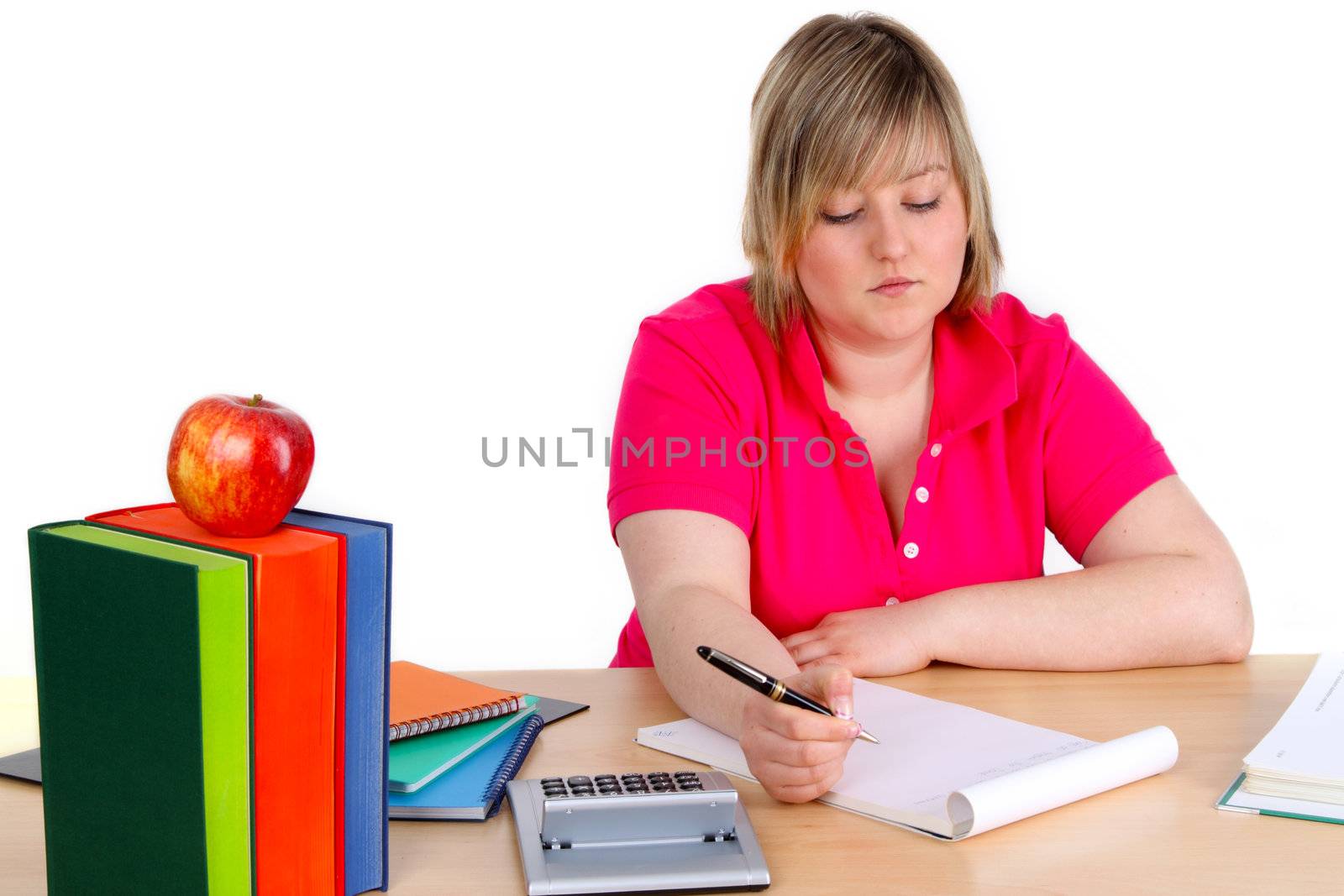 Young female student is writing on white background