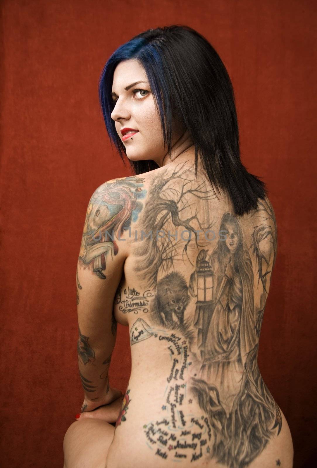 Woman with a tattoo on her back by Creatista