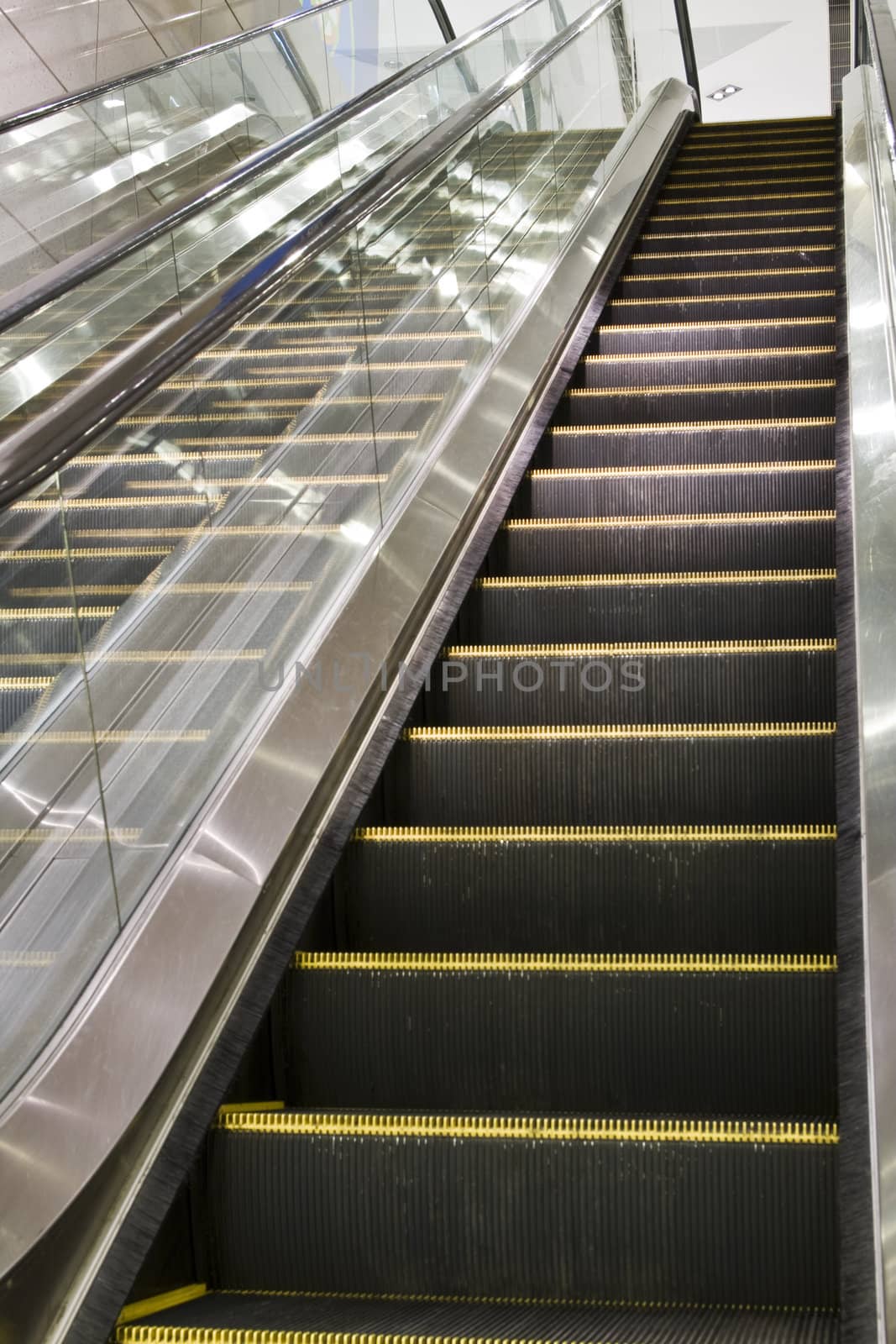 escalator in a building. by cozyta