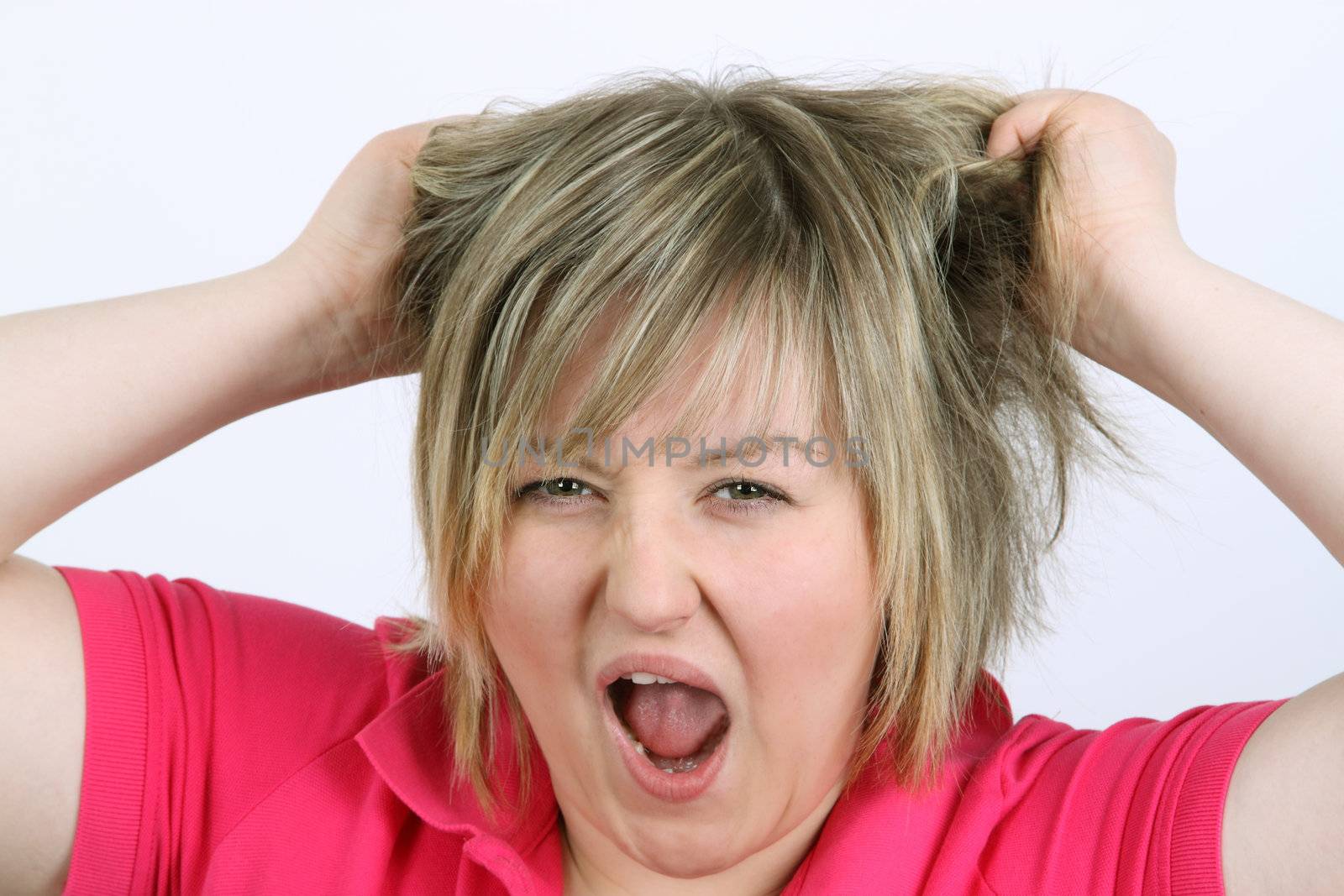 Young screaming woman on white background. Shot in studio.