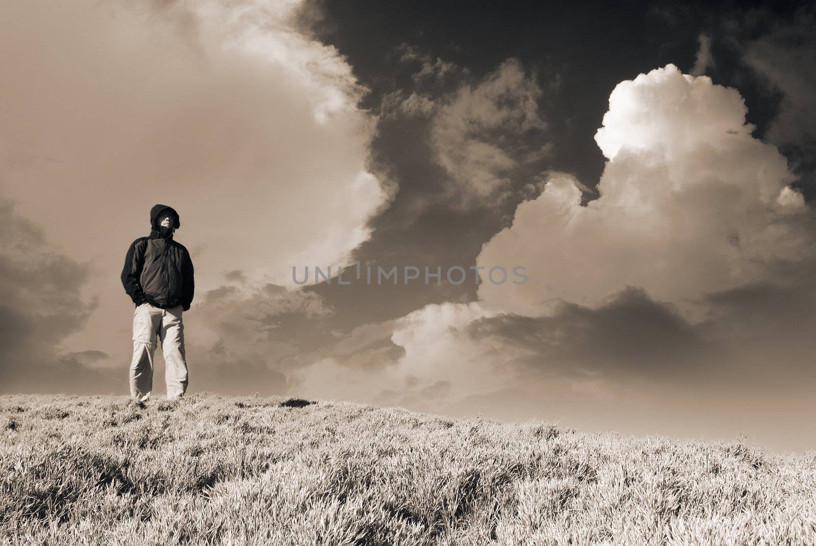 Dramatic landscape of clouds and sky, one guy stand and watch in the outdoor.