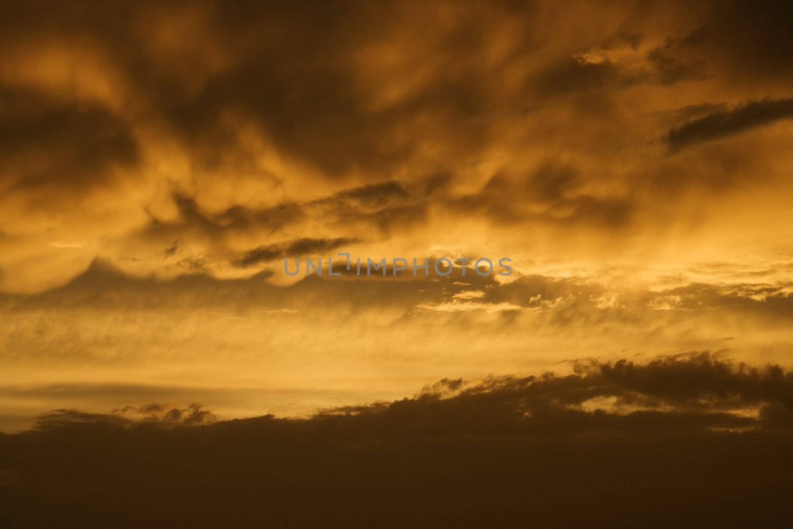 Golden yellow and orange sunset sky and clouds.