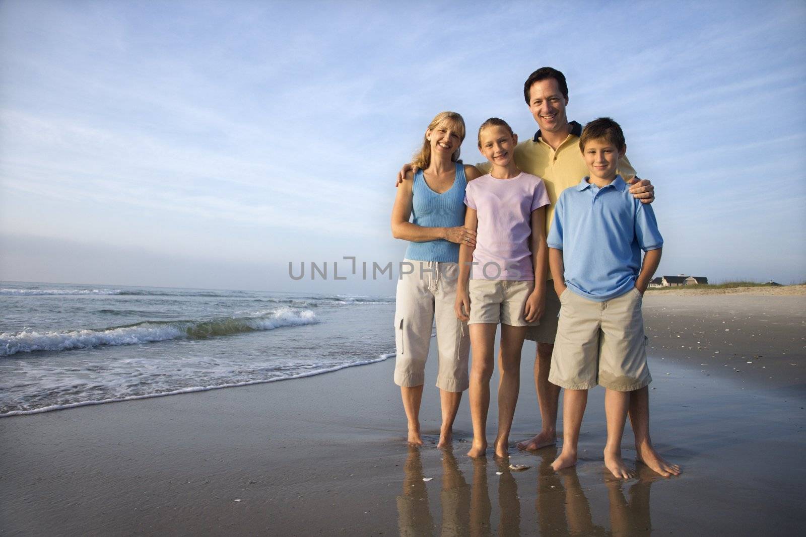 Smiling family on beach. by iofoto
