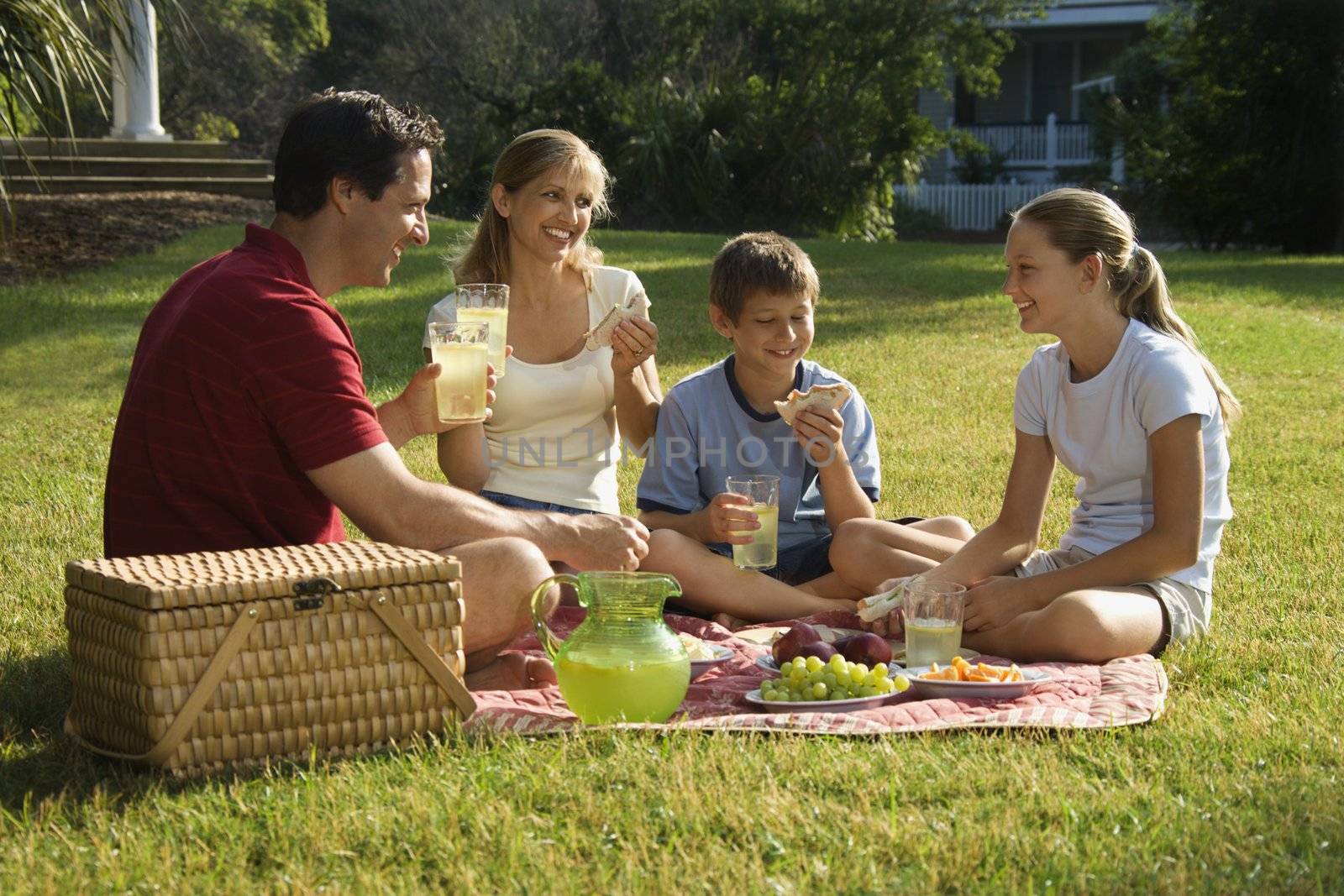 Family having picnic. by iofoto