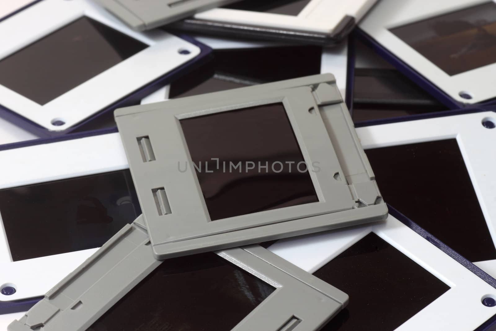 Pile of framed slides as background. Shot in studio.