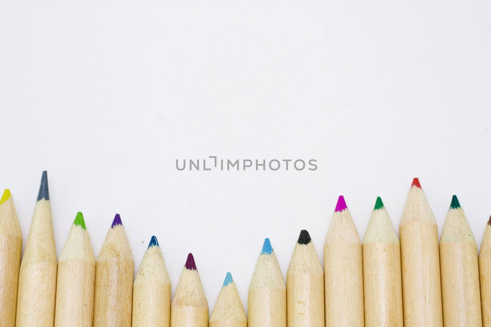 Colored pencils forming a color row. White background.