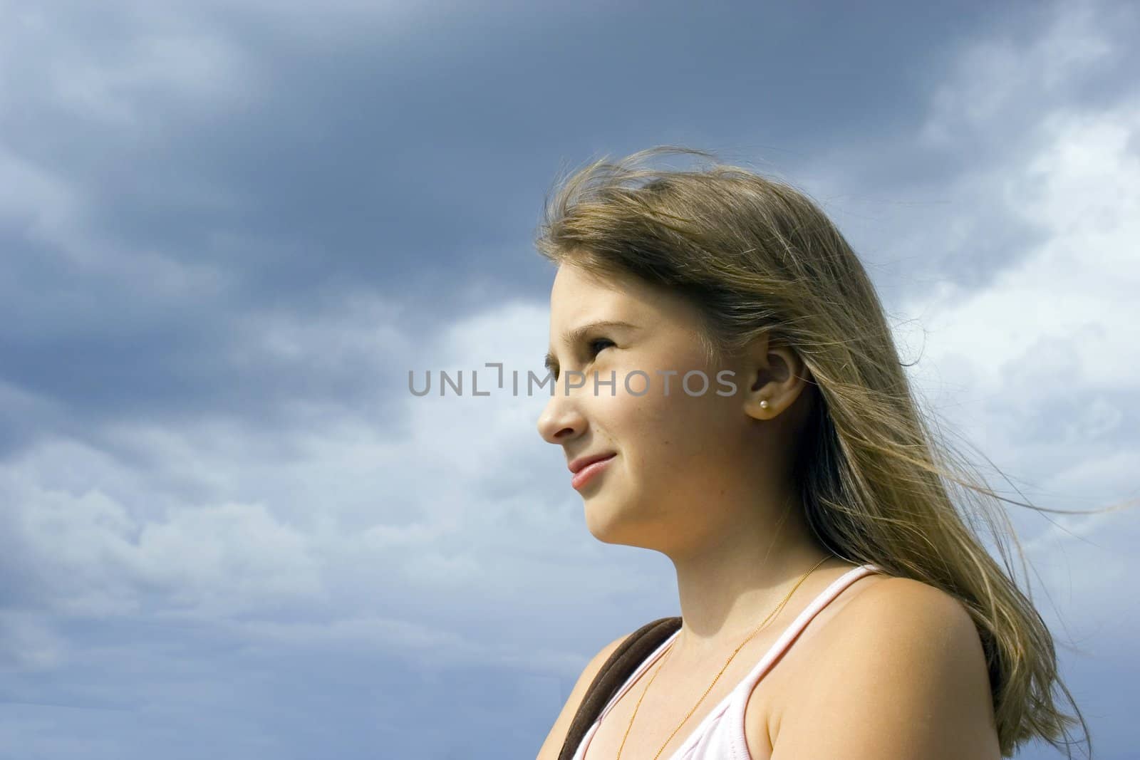 Young girl look forward on sky background