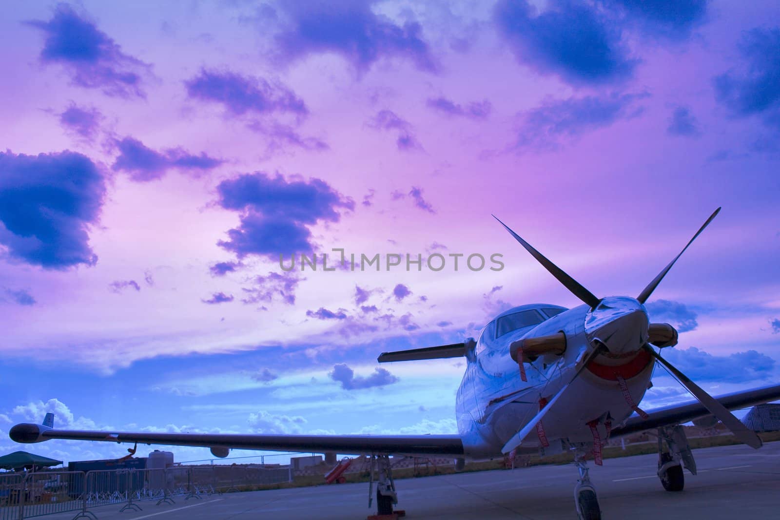 Business airplane in airport. Sunset light background.