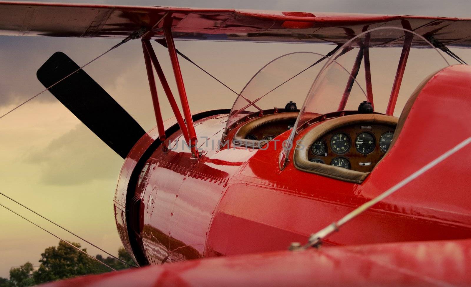 Red twoseater airplane on parking of airport