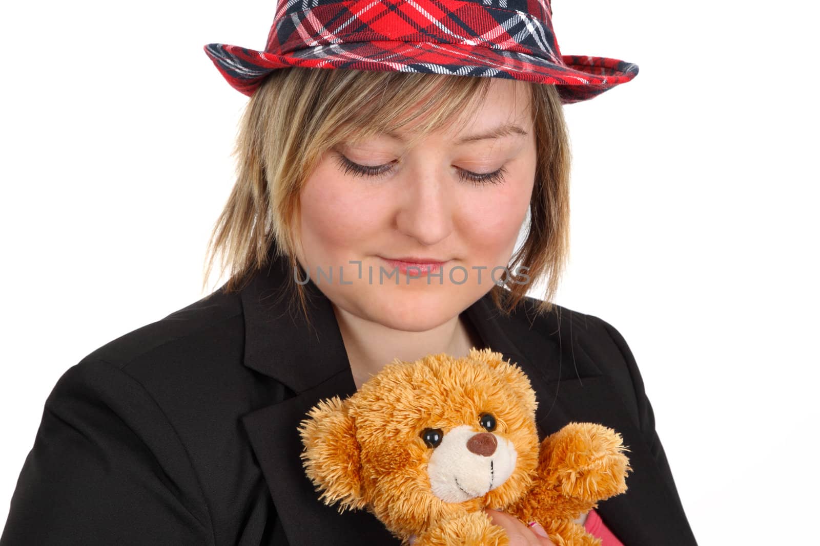 Young woman holding a teddy bear on white background