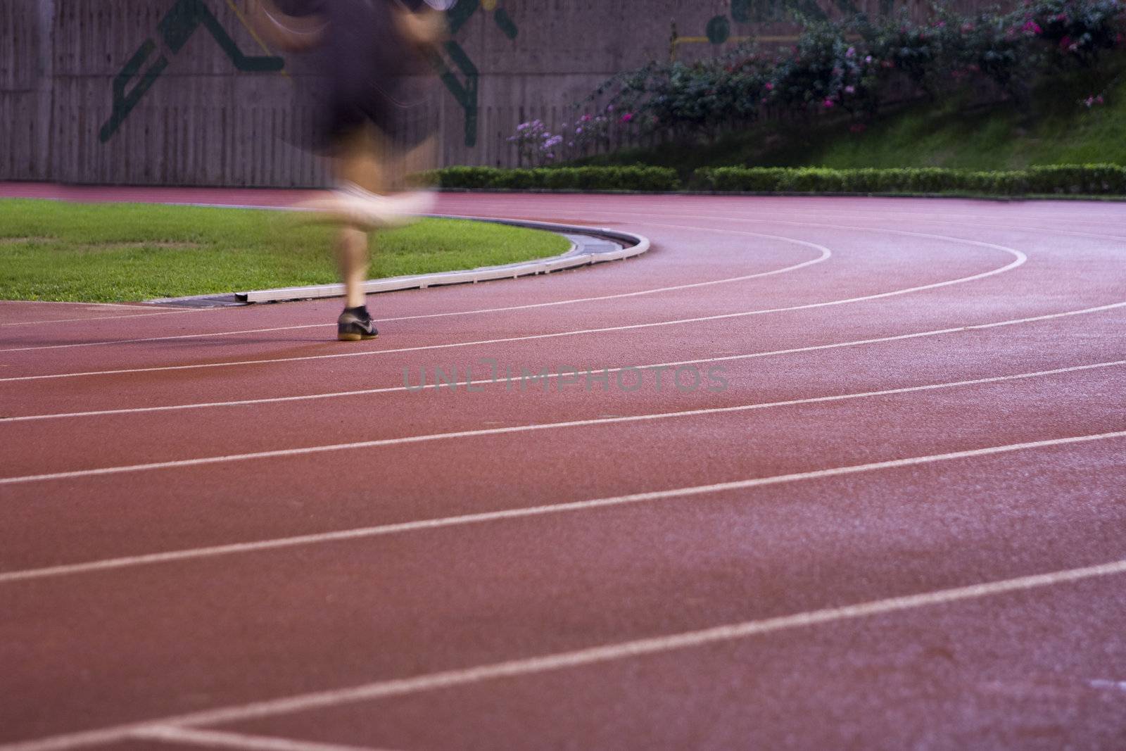 It is a man running in play gorund lanes on a track