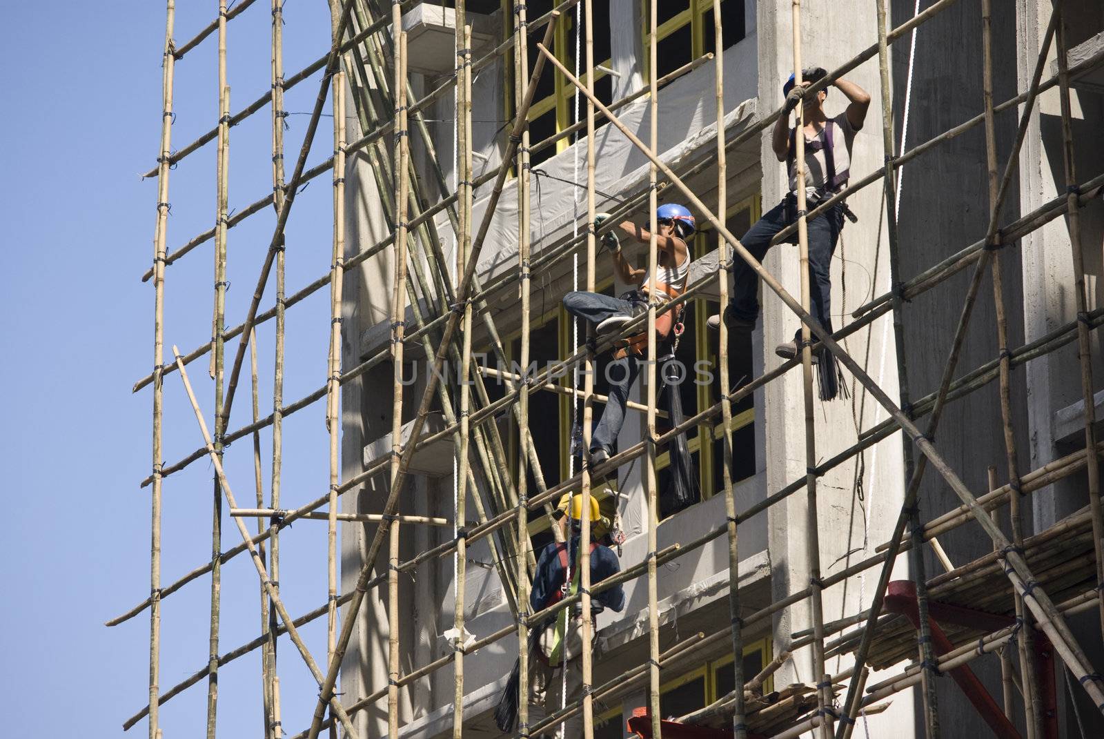 worker working at the construction side that are bamboo scaffolding