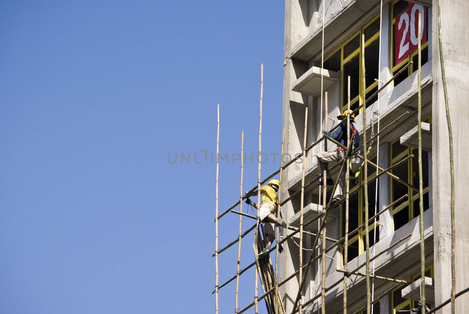 worker working at the construction side that are bamboo scaffolding