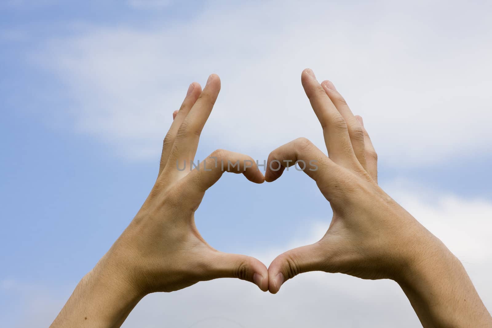 Hand with the Sky Background
to show a heart.