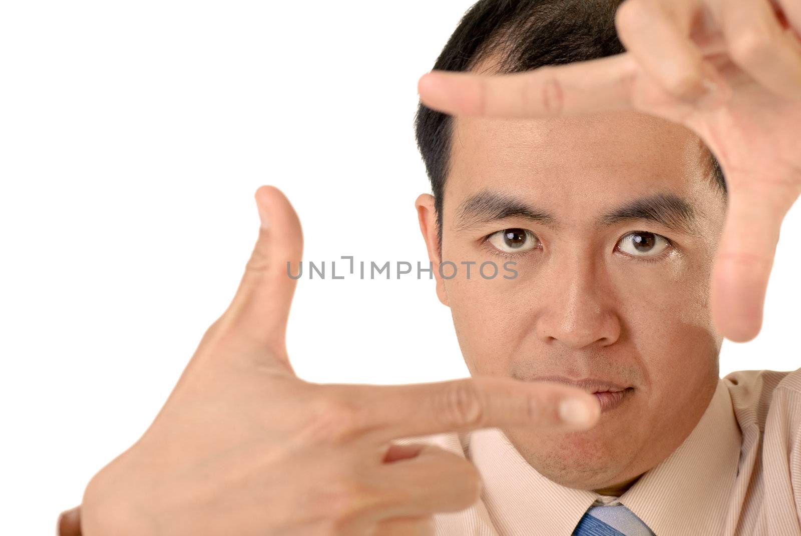 Businessman in focus by hands with confident expression on white background.