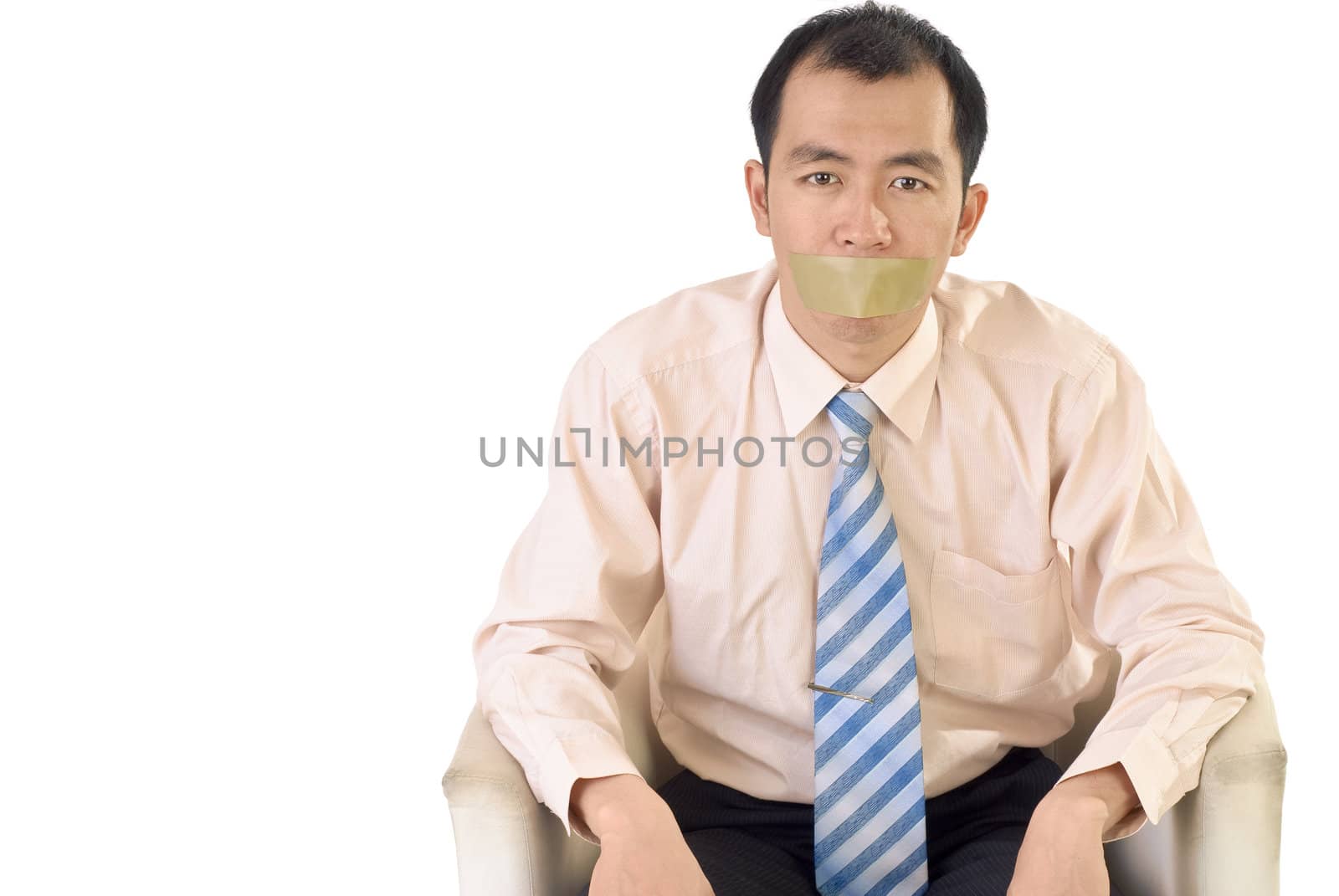 Silent businessman with tape on mouth sit on white background.
