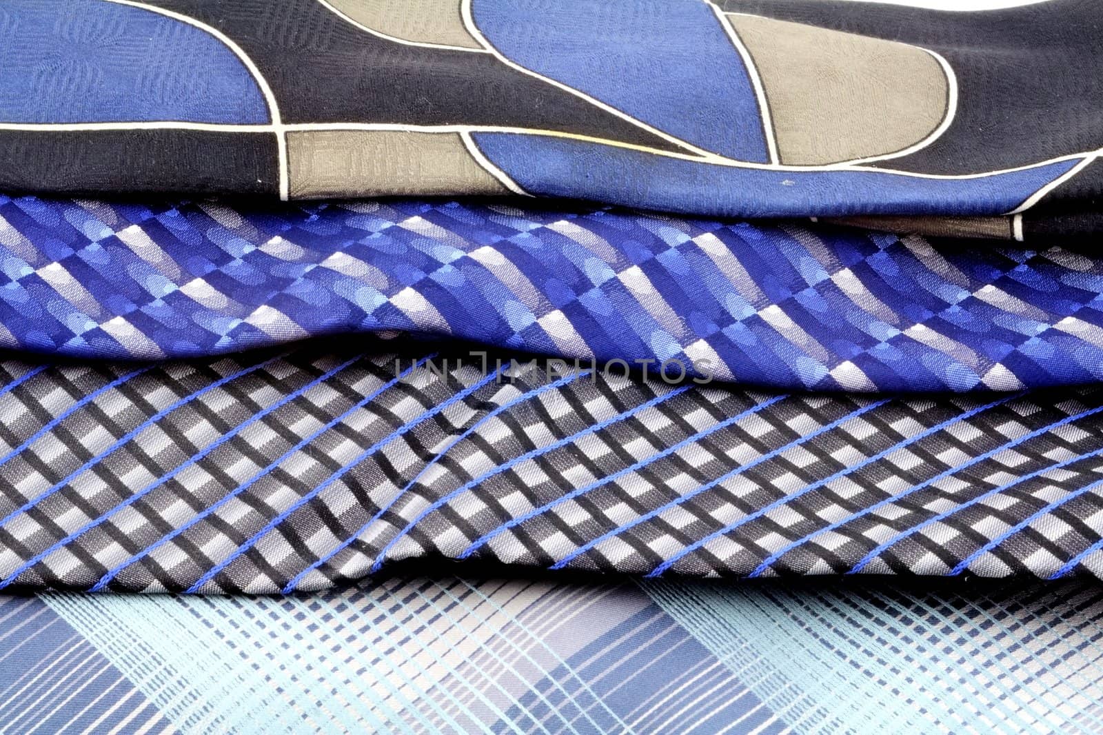 A group of four blue neck ties isolated on white.
