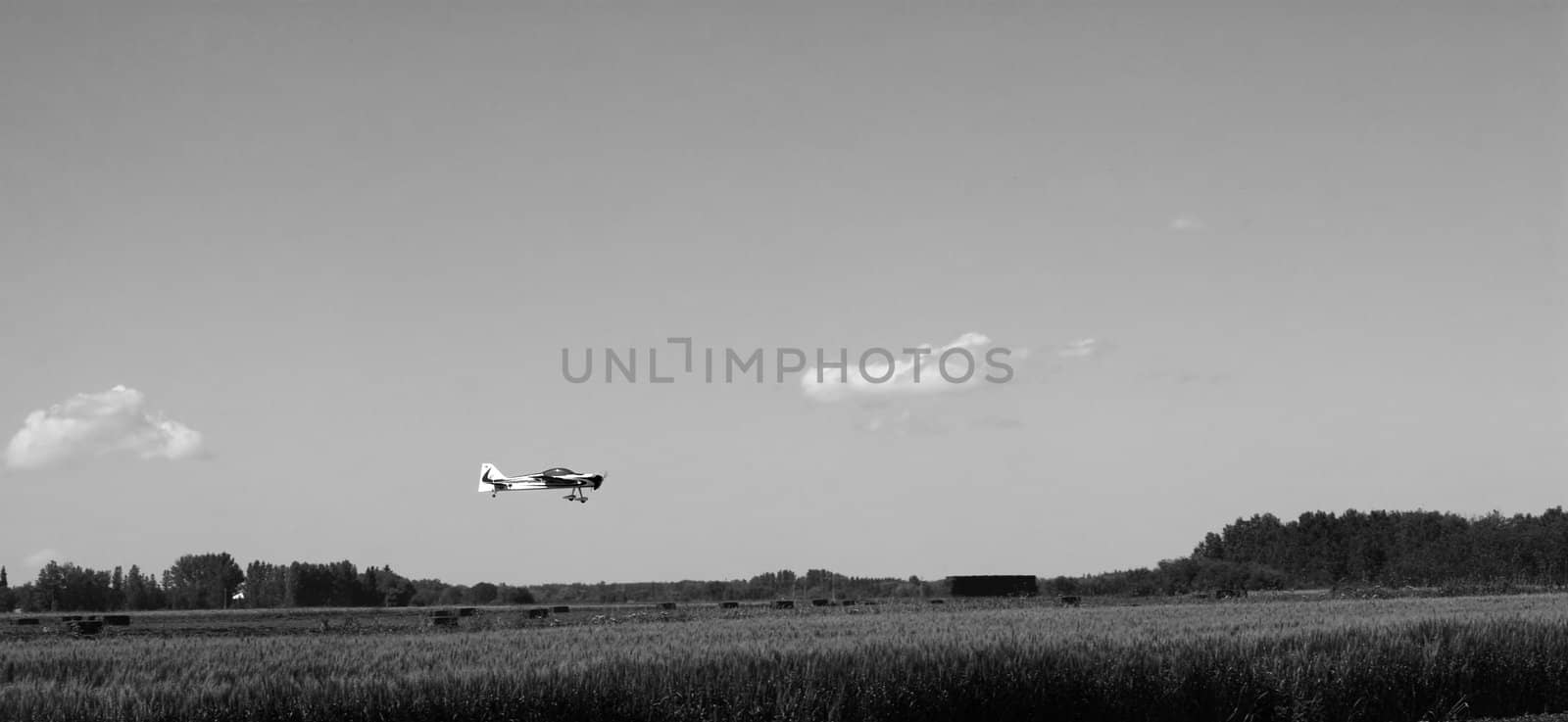 A small remote controlled plane landing in a field