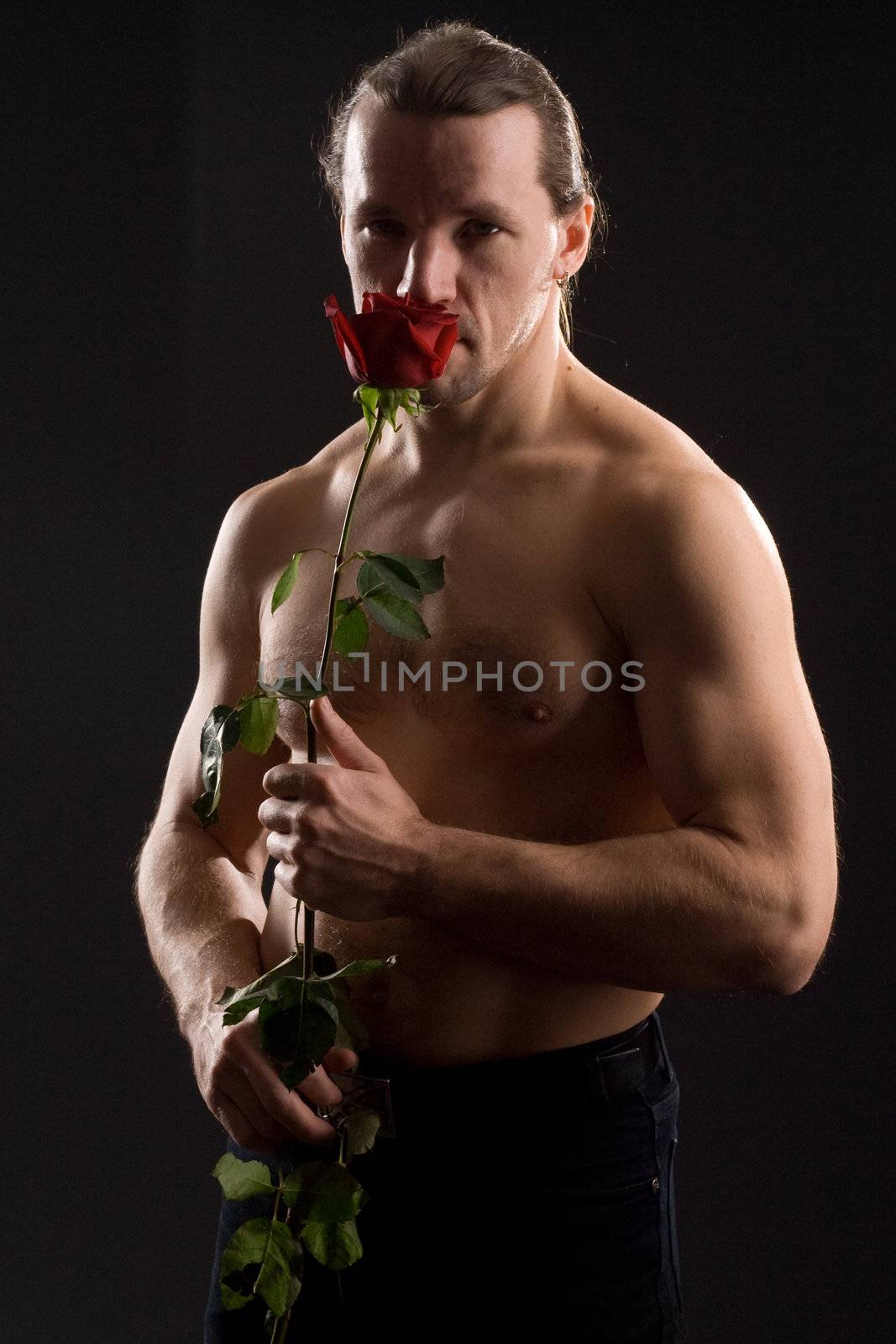 standing romantic man with red rose
