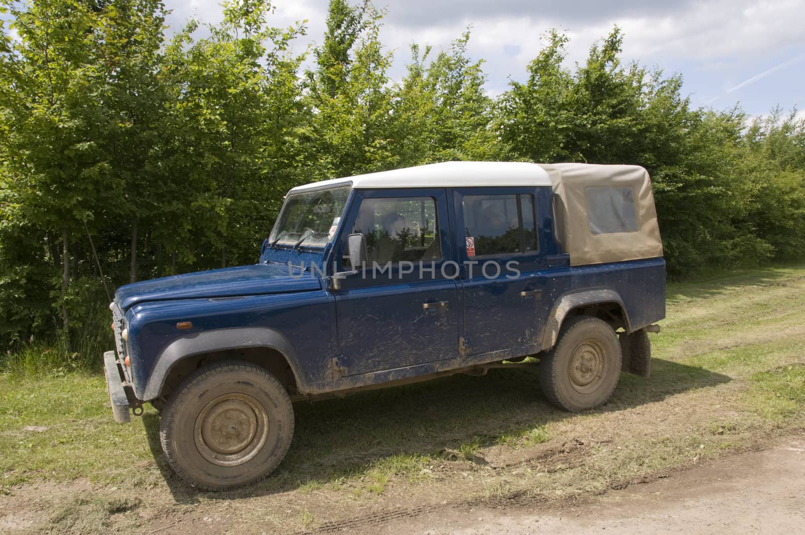 A four wheel drive truck on a farm track