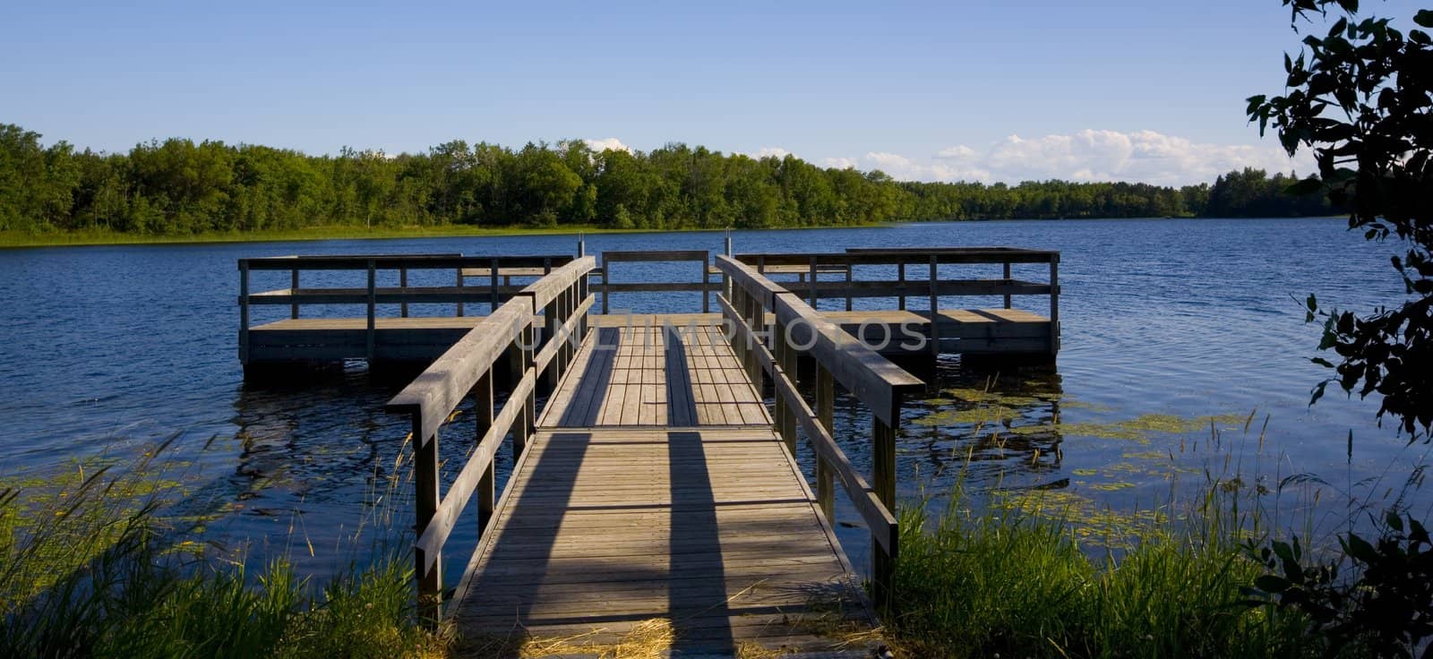 A fishing pier in a blue lake in Northern Minnesota.