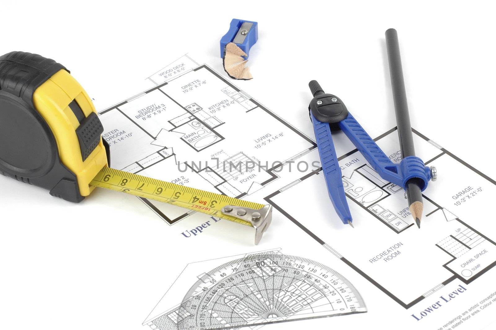 Drafting tools and blueprints on a white background.