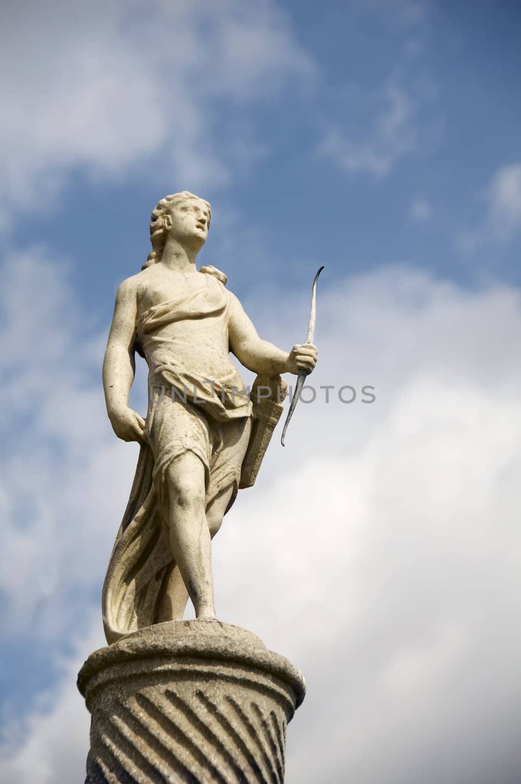 A stone statue with sky in the bckround