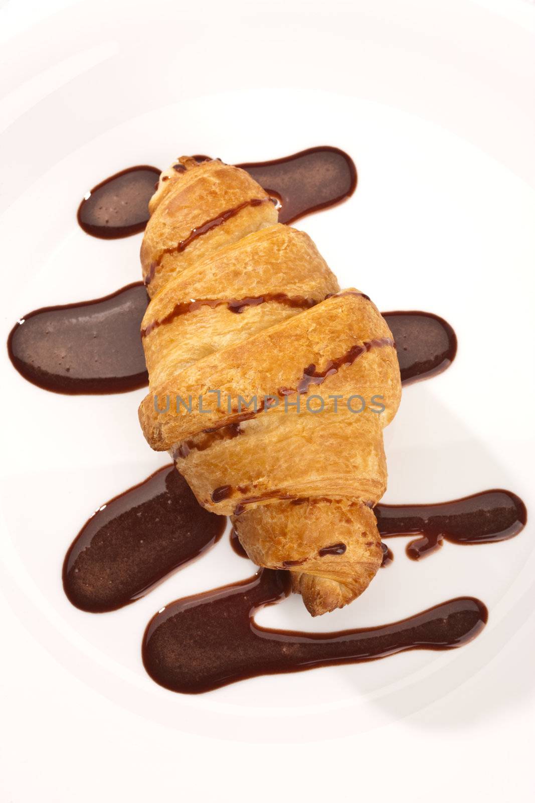 food series: tasty fresh croissant on plate with chocolate