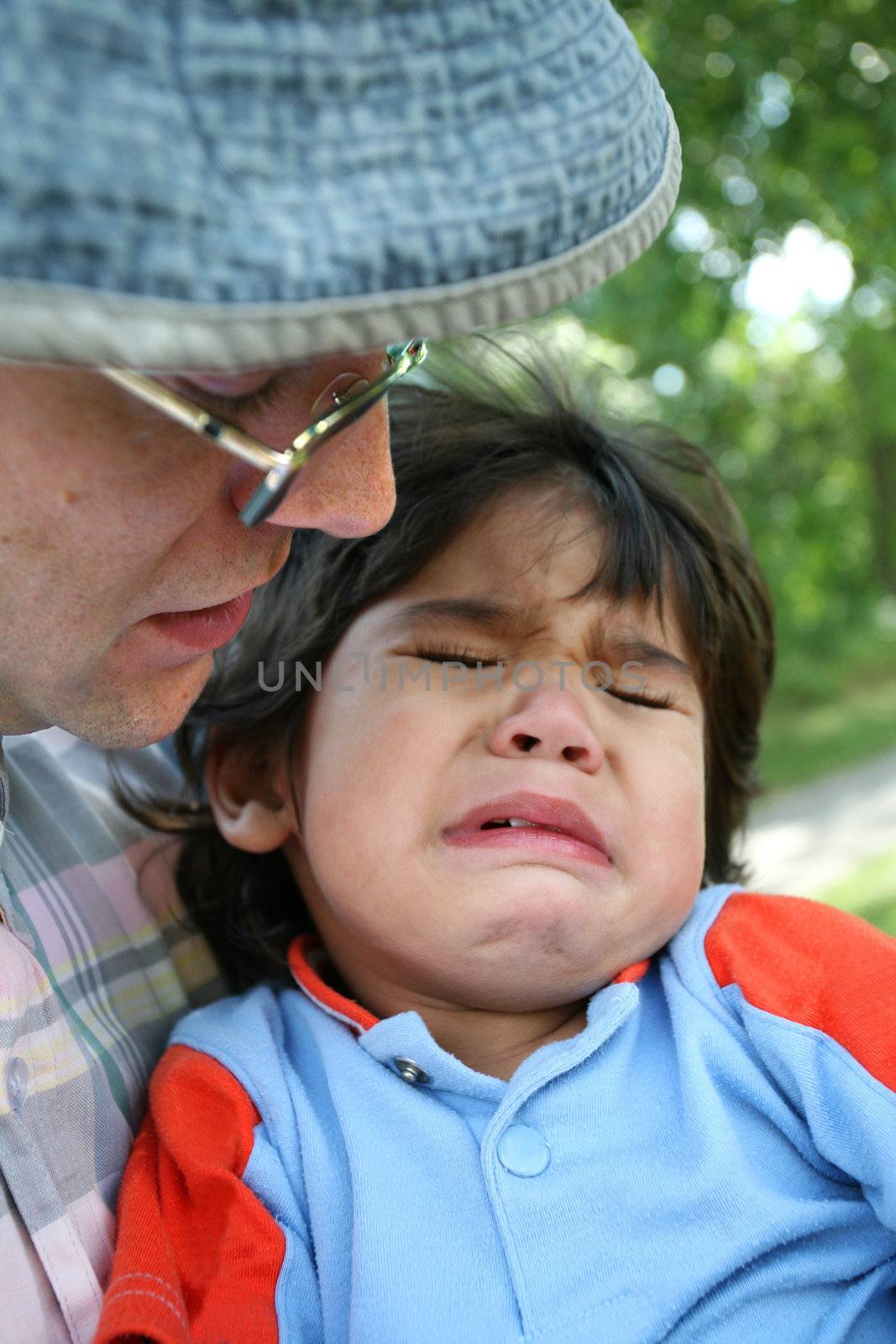 Father consoling crying toddler